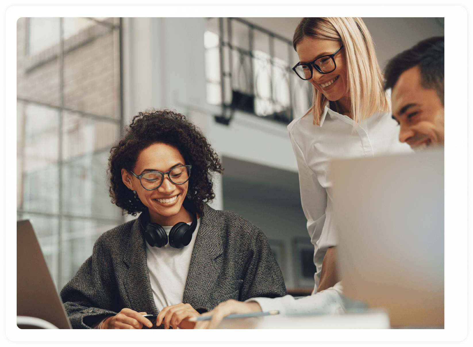 Hero image screenshot of two employees smiling at their work