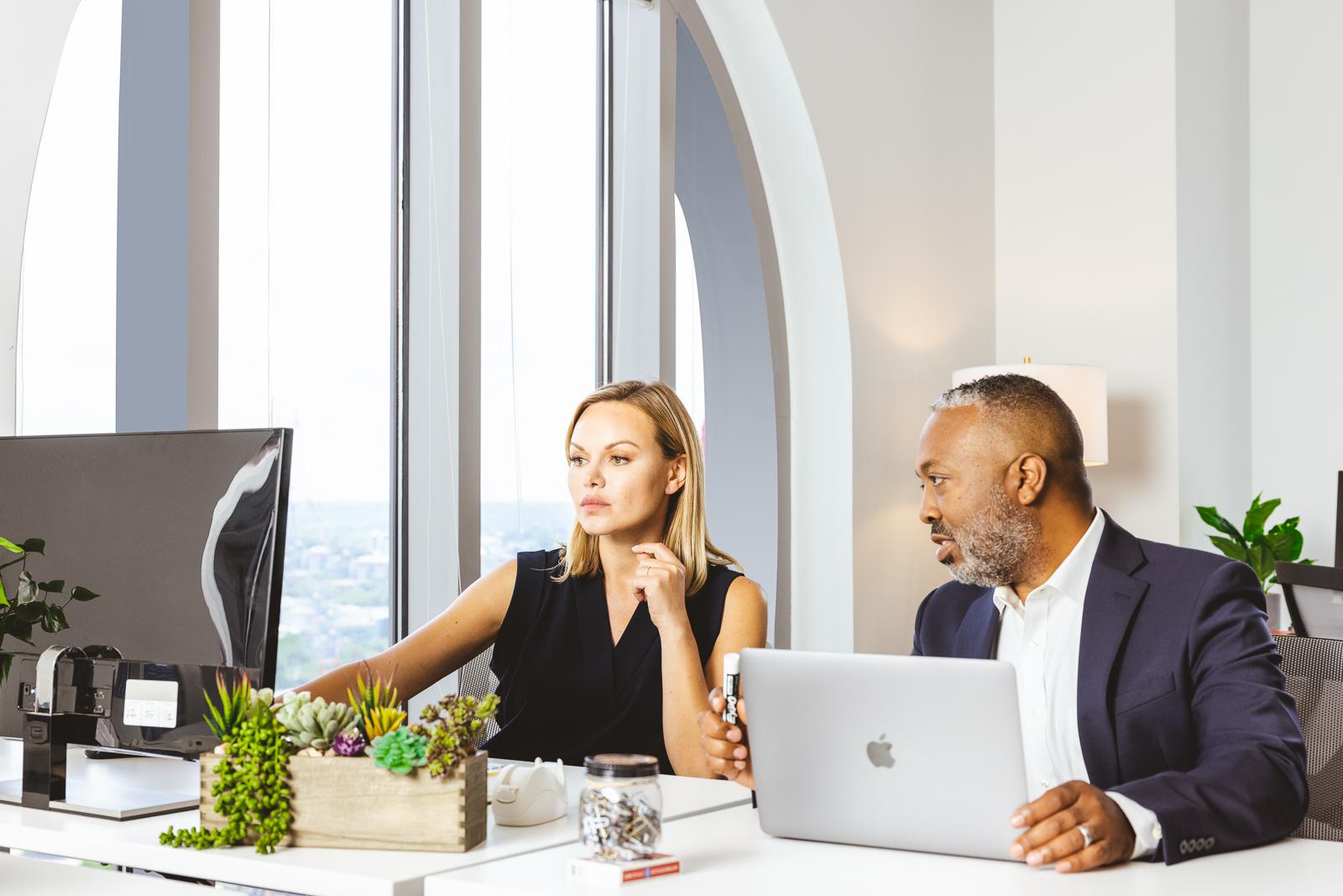 Two people working on a computer