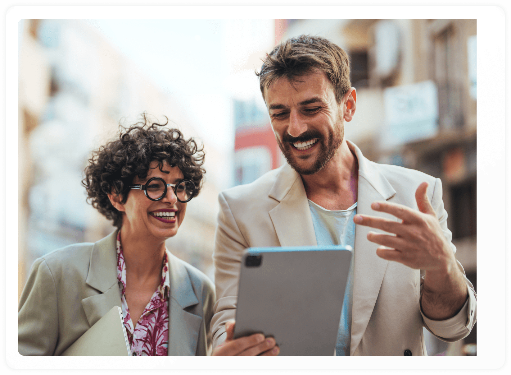 Hero image screenshot of two employees smiling at their work