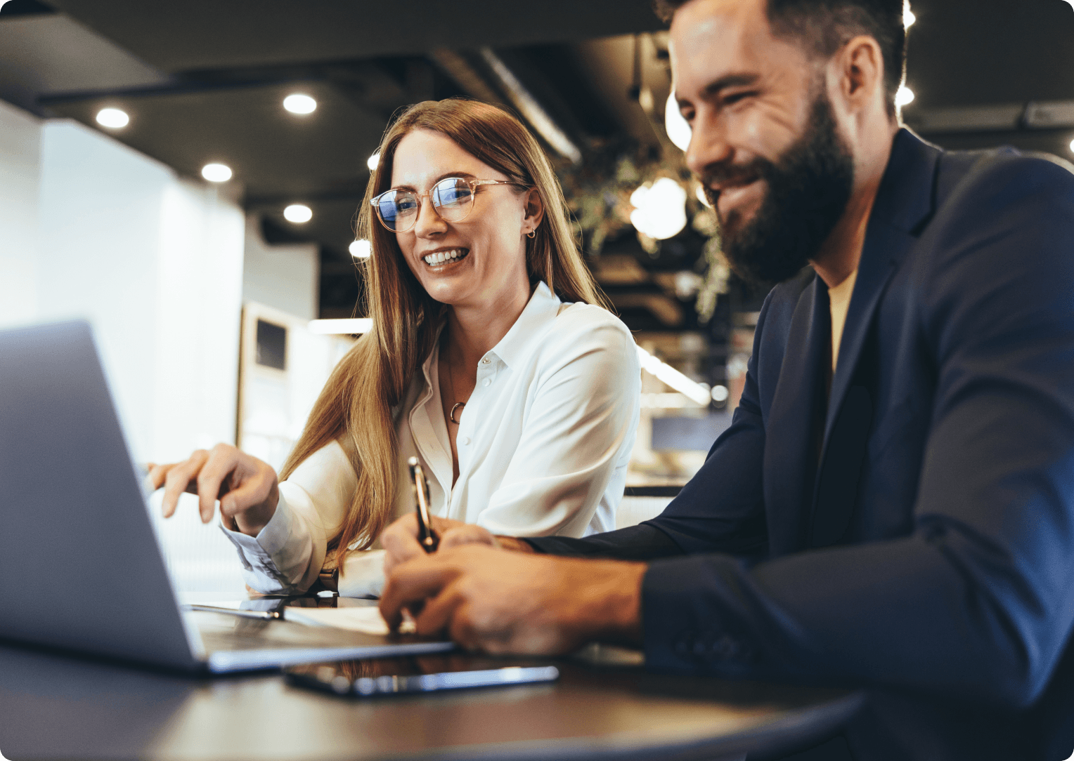 Two people working on a laptop